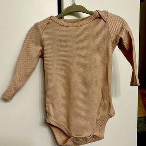 Tan Long-john onesie Clasps on bottom Ribbed texture Soft. Breathable Longsleeve